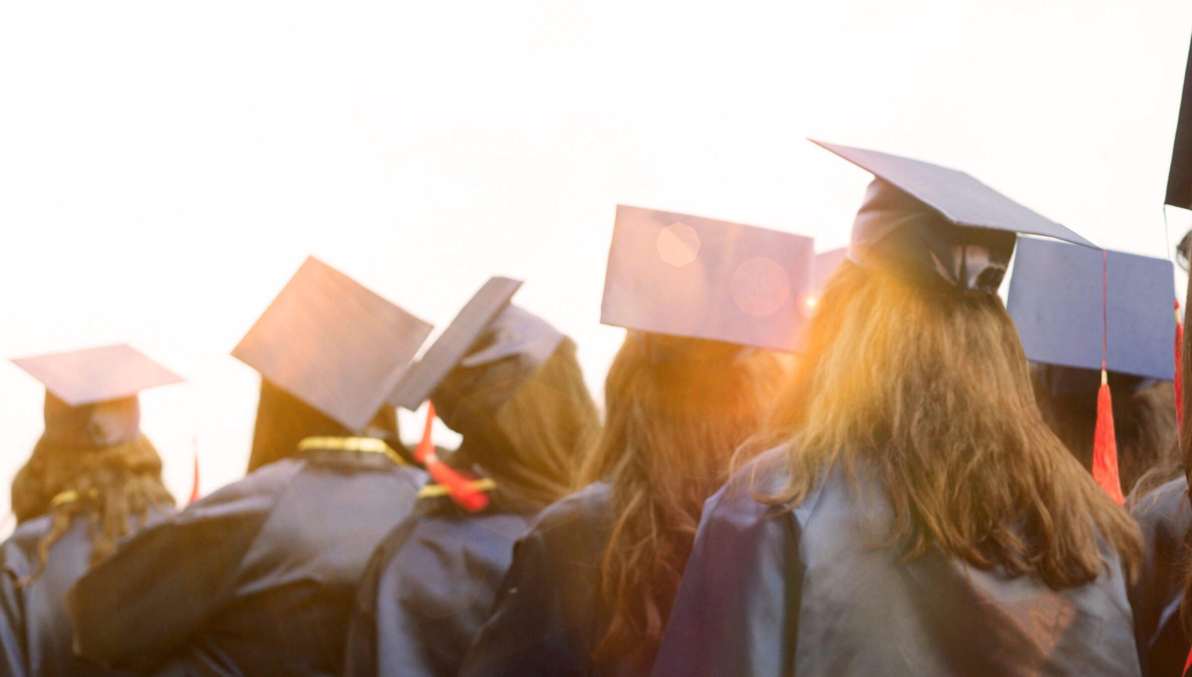 A cluster of students gathered together in caps and gowns